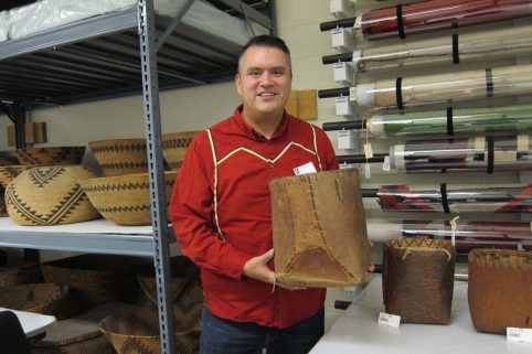 Michael Finley holding a traditional birch bark basket.