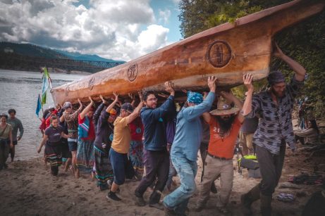 Photo of Sinixt people lifting the canoe at the annual canoe journey in Kettle Falls, WA